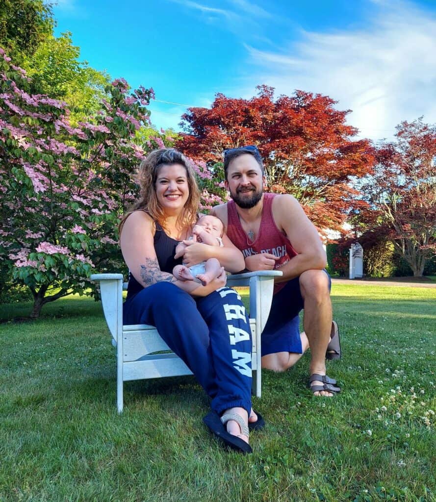 amy nathan and malcolm sitting in a beautiful flower garden in cape cod ma, summer time