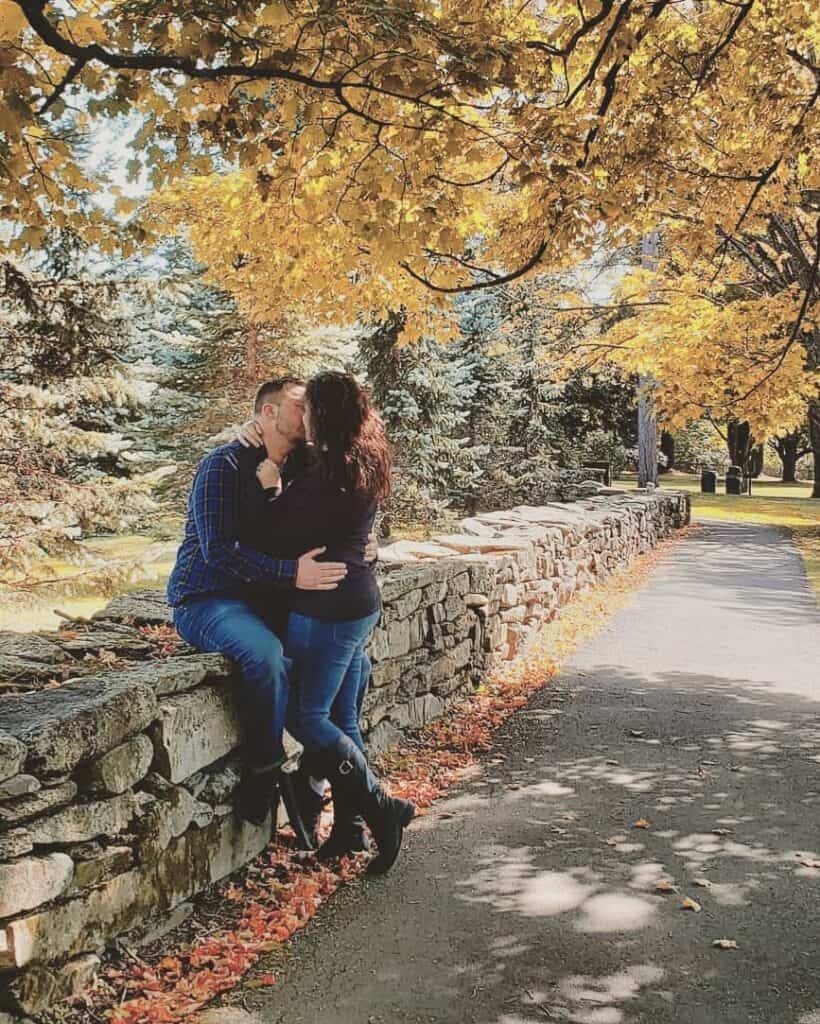 a couple kissing under a golden autumn tree, woodstock vt fall swcene