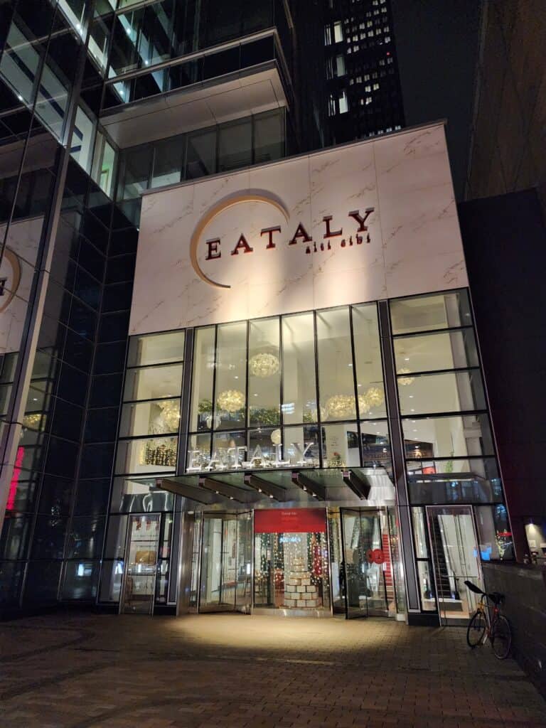 impressive exterior to entrance of a Boston restaurant called EATALY set among the sky scrapers of the city