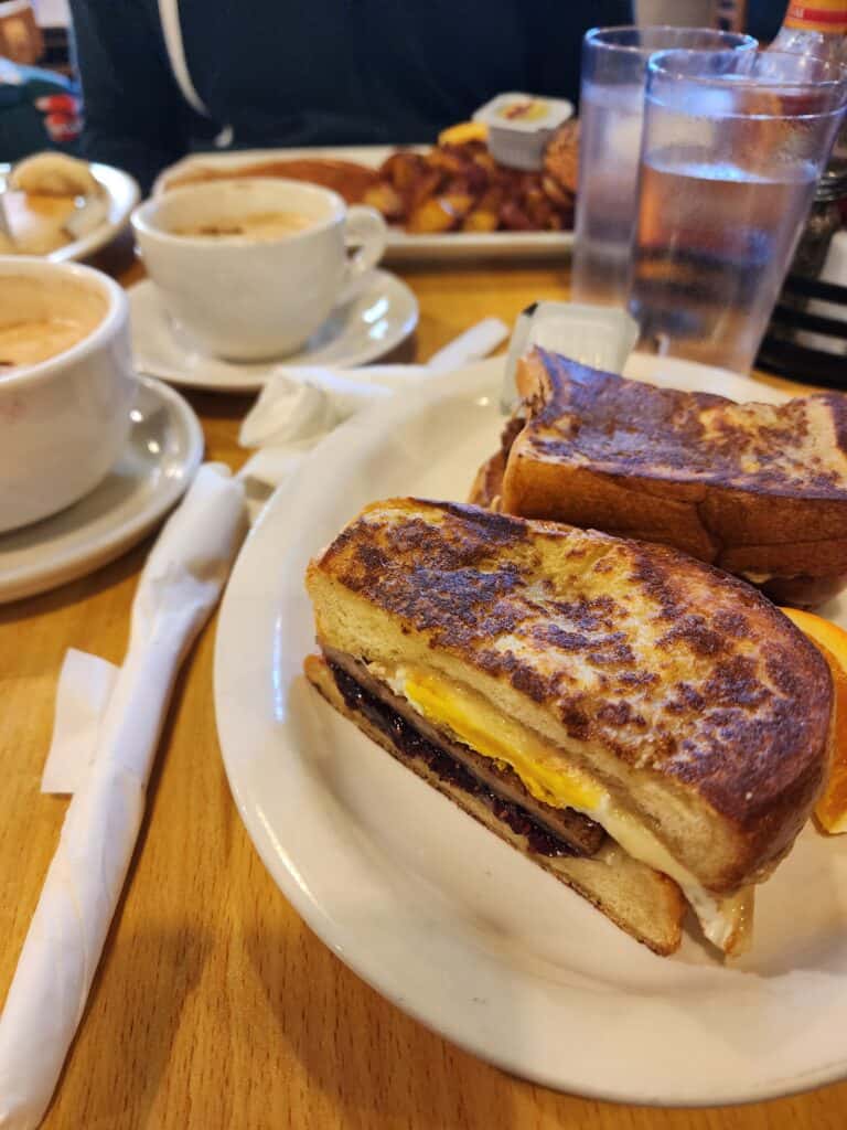 Close-up of a scrumptious breakfast sandwich with a side of coffee, a staple for a foodie's morning in Boston, inviting a taste of the local cuisine
