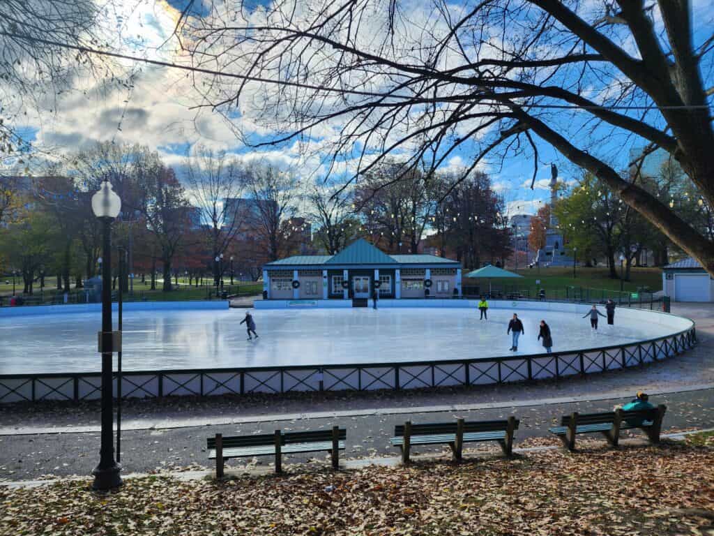An outdoor ice skating rink in Boston common as seen on a cold winter day
