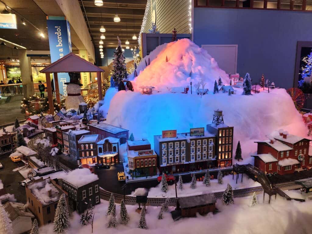 Am elaborate model train setup amongst a snowy Christmas village at the Boston museum of science