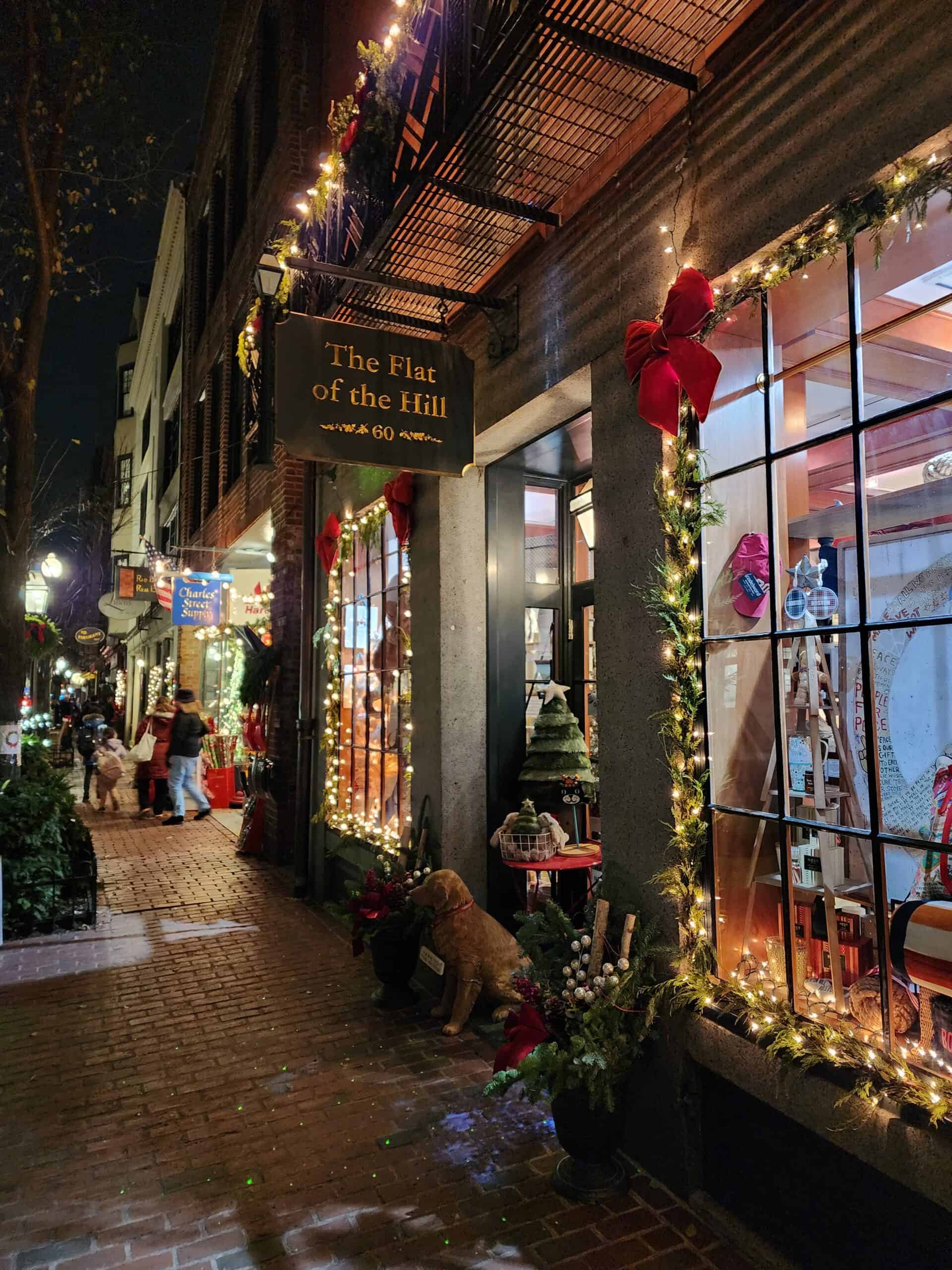 A festive street in Beacon hill Boston decorated for Christmas and lit up at night for the Christmas stroll