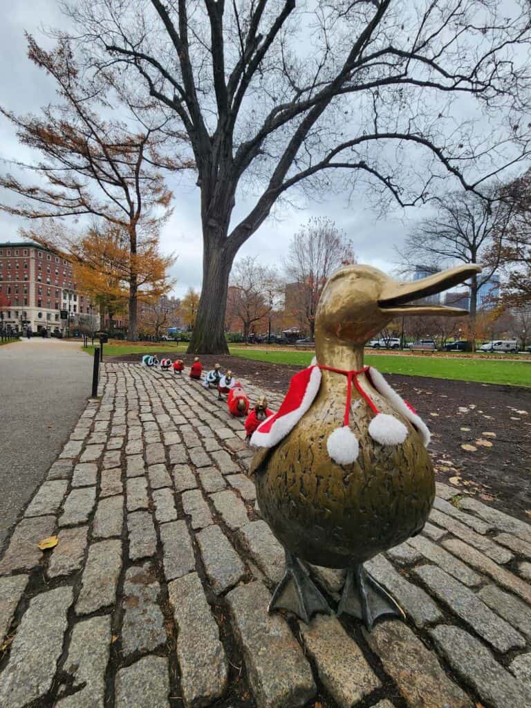 The bronze "make way for ducklings" statues in Boston common are seen decked out in festive holiday hats and capes 
