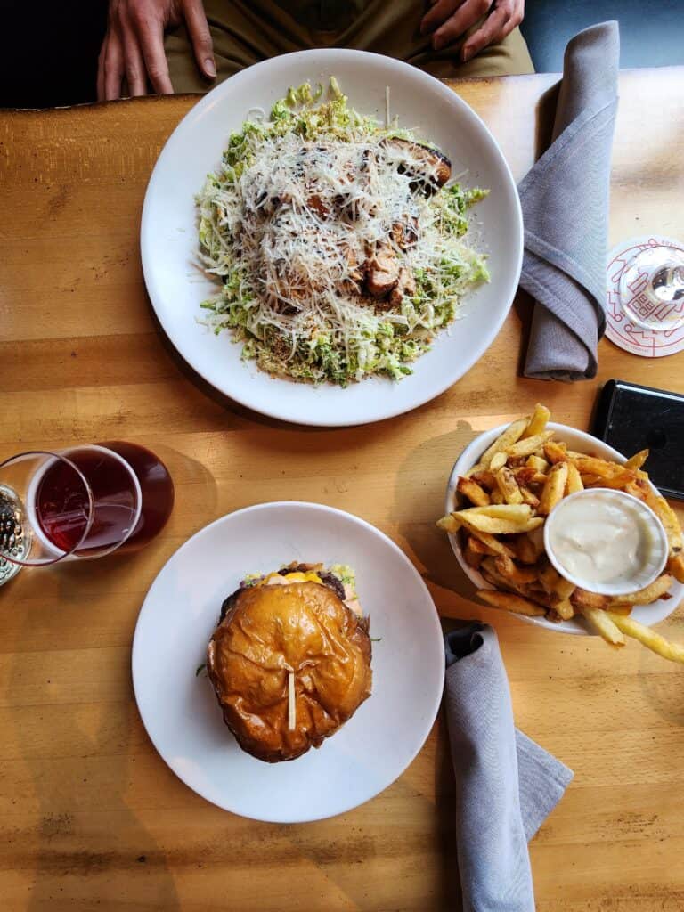 A burger, fries, salad, and beer as seen from above at Burlington Beer Co in Burlington, Vermont