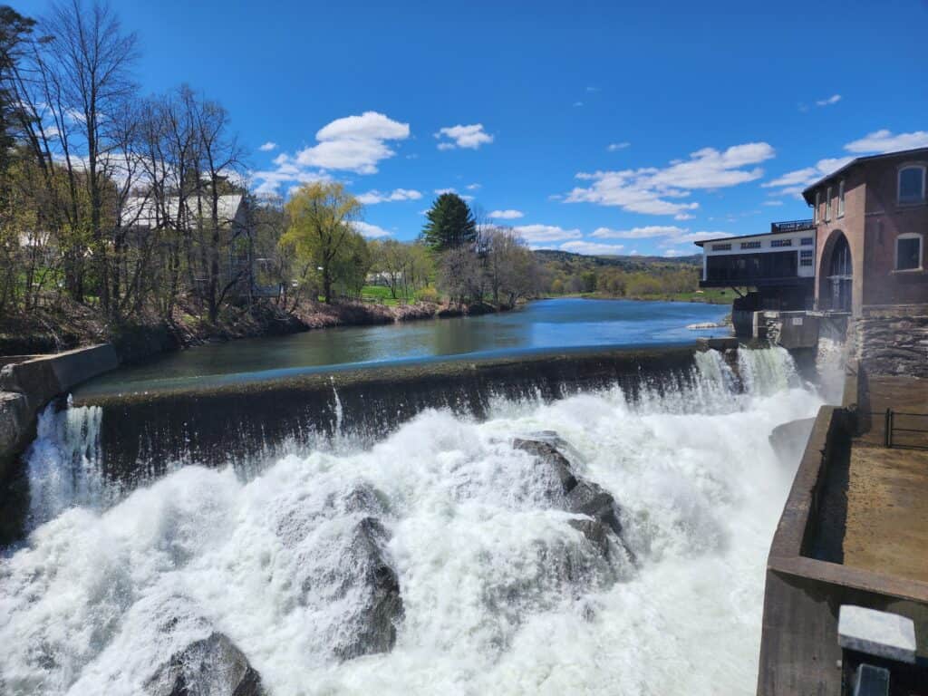 The Ottauquechee River waterfall outside Simon Pearce in Quechee, Vermont in May as the trees are coming back to life along its banks