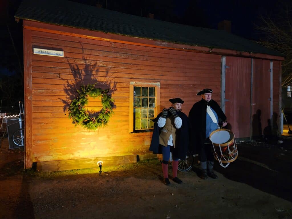 Carolers dressed in historical costume at Strawbery Banke Museum in Portsmouth, New Hampshire at Christmas